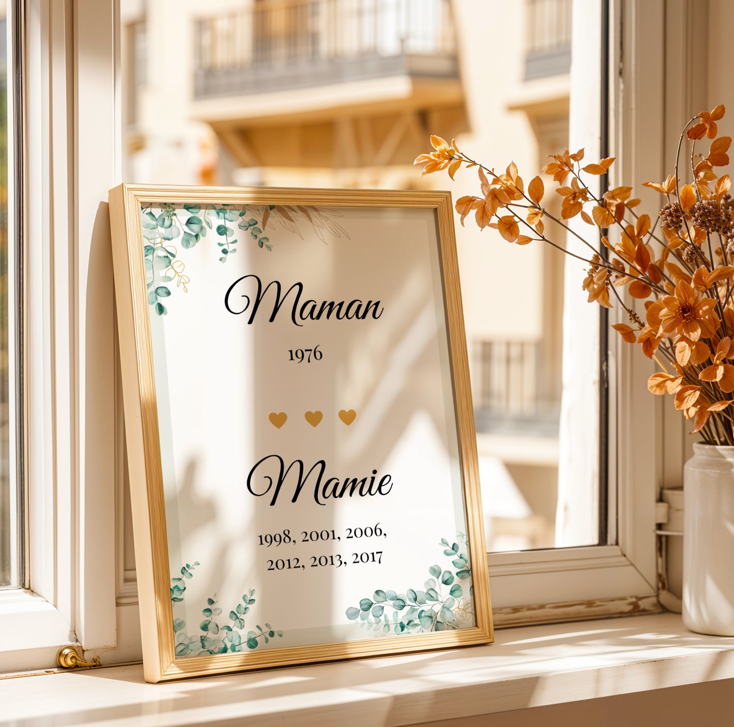 Affiche Mamie Personnalisée with "Maman" and "Mamie" text, birth years, gold hearts, and green leaf accents for Fête des.