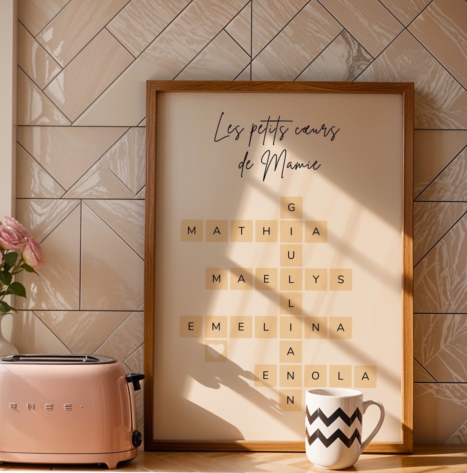 Affiche Mamie Personnalisée with grandchildren's names arranged like Scrabble tiles in a wooden frame against tiled wall for .