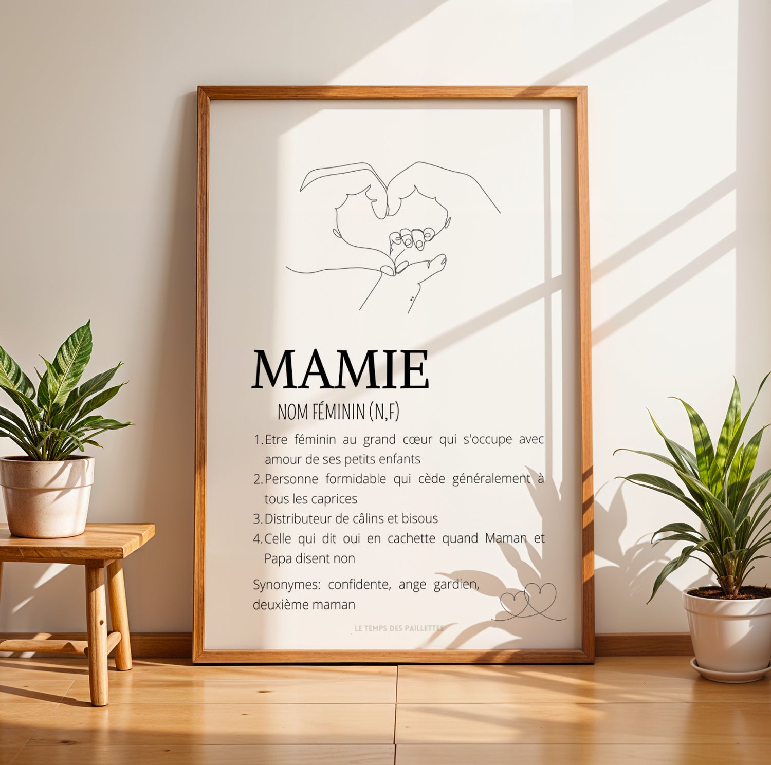 Framed minimalist Affiche Mamie Personnalisée with line art of hands and Fête des Grands-Mères text in black on white.